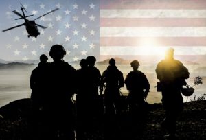 Silhouettes of soldiers during Military Mission against American flag